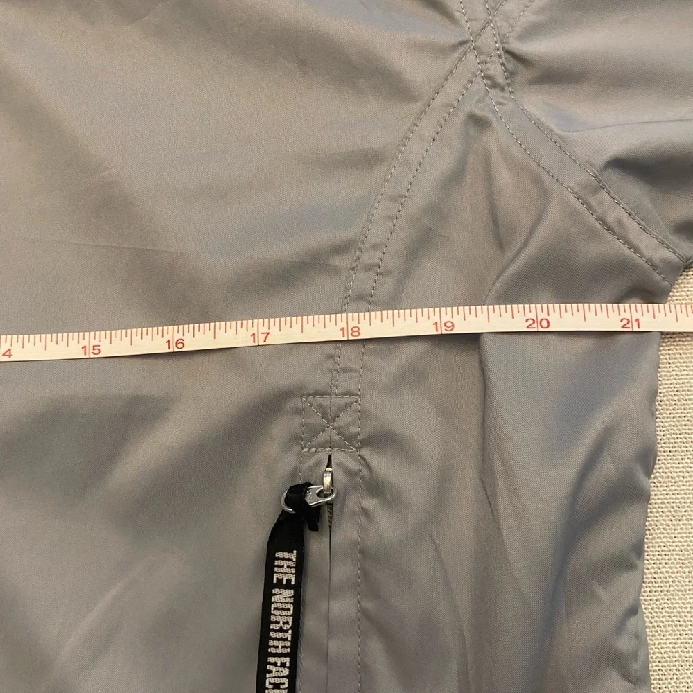 The North Face Men's Gray Windbreaker with Red Accents Size M.
